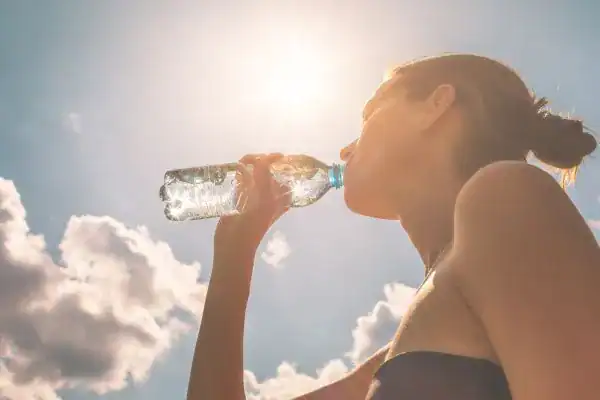 Hydration: The Secret Ingredient for a Toned Stomach and Enhanced Fitness 3 Image of woman drinking water to hydrate Southend-on-Sea after run.